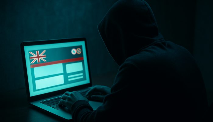 Guarding Against Clone Lender Websites: Stay Safe Online | DCL Hacker forging fake UK bank website with mirrored logos on glowing laptop screen
